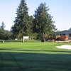 A view of the 9th green with the clubhouse behind at Evergreen Golf Club.