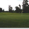Colwood National: Hole #5 is a dogleg left that turns about 200 yards out (left center tree in photo). A small lake guards the left and will come into play more if your drive is short of the turn. Mounds of rough with no bunkers surround the green