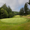 A view of the green at Coos Golf Club's par-4 fifth is elevated and protected by the sand bunker from the front.