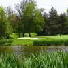 Eastmoreland #12: Hole #12 is mostly water from tee to green. A deep bunker guards the left-front of the green and trees line the back and right. The green pitches sharply to the front-right.