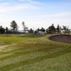 Doesn't look like there's a flat lie from tee to green on the 3rd. The fairway rolls left and right the entire way. A huge mound with a very deep bunker guards the front of the green. The top of the flag can barely be seen.