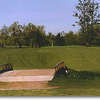 Hole #14 runs in the opposite direction as #13. The creek and trees are to the right and houses to the left. The creek runs across the fairway about 100 yards out.