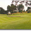 Hole #1 is a dogleg right with a tree in the middle of the fairway that leads to an elevated green. A bunker protects the green in front and to the back-left