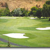 Hole #6 starts with a downhill tee shot to a fairway with a bunker on the left and one on the right. Trees also line both sides. The slight dogleg right leads to a green that is relatively flat and protected by two more bunkers left and right front of the