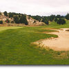 Ocean Dunes #2: This par 5 starts from an elevated tee and then dogleg's right to an elevated green. The tee area is located in the distance above the two trees jutting into the fairway. Two more large bunkers are located on the other side of the green an