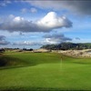 Ocean Dunes #4: Hole #4 is a sharp dogleg left about half way to the two tiered green. The fairway rolls down and then up to the green. Large mounds of rough surround the green with one very large and deep grass bunker to the right.