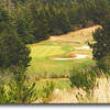 Ocean Dunes #17: A breathtaking view of the 17th green from the tee area. The hole is 150 yards out and 60 feet down from the blue tees so correct club selection is important. Bunkers guard the right side and trees are left.