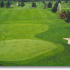 Hole #18: The longest hole on the course. Trees line the fairway and a deep bunker protects the left side of the green.