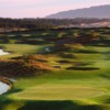 Florence Golf Links hole #16. Your tee shot must be left center to avoid the Scottish style bunkers on the right. The green is surrounded by hazards. Water, deep bunkers, and rough are waiting. The massive coastal sand dunes can be seen in the distance. 