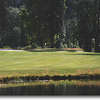 Tokatee #6: Trees line both sides of the fairway with a pond that juts into the fairway on the right. The green has one large bunker on the left and rough that drops off on the back and right side