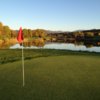 View of a green and lake at Stone Ridge Golf Club