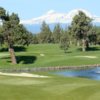 A view of a green with snowy mountains in background from Greens at Redmond