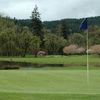 A view of green with water in background at Middlefield Village Golf Course