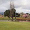 A view of green with bridge over the water on the right at Umpqua Golf Resort