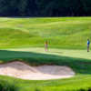 A view of a green protected by bunkers at Oswego Lake Country Club.