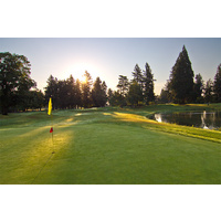 A look at the fifth green with flagstick and water hazard on the right of the tee boxes at Rose City Golf Course in Portland, Oregon.